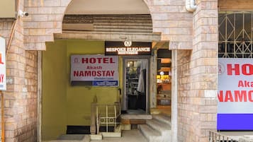 A hotel entrance with a sign for 'Hotel Namostay' and 'Bespoke Elegance Boutique' above it.