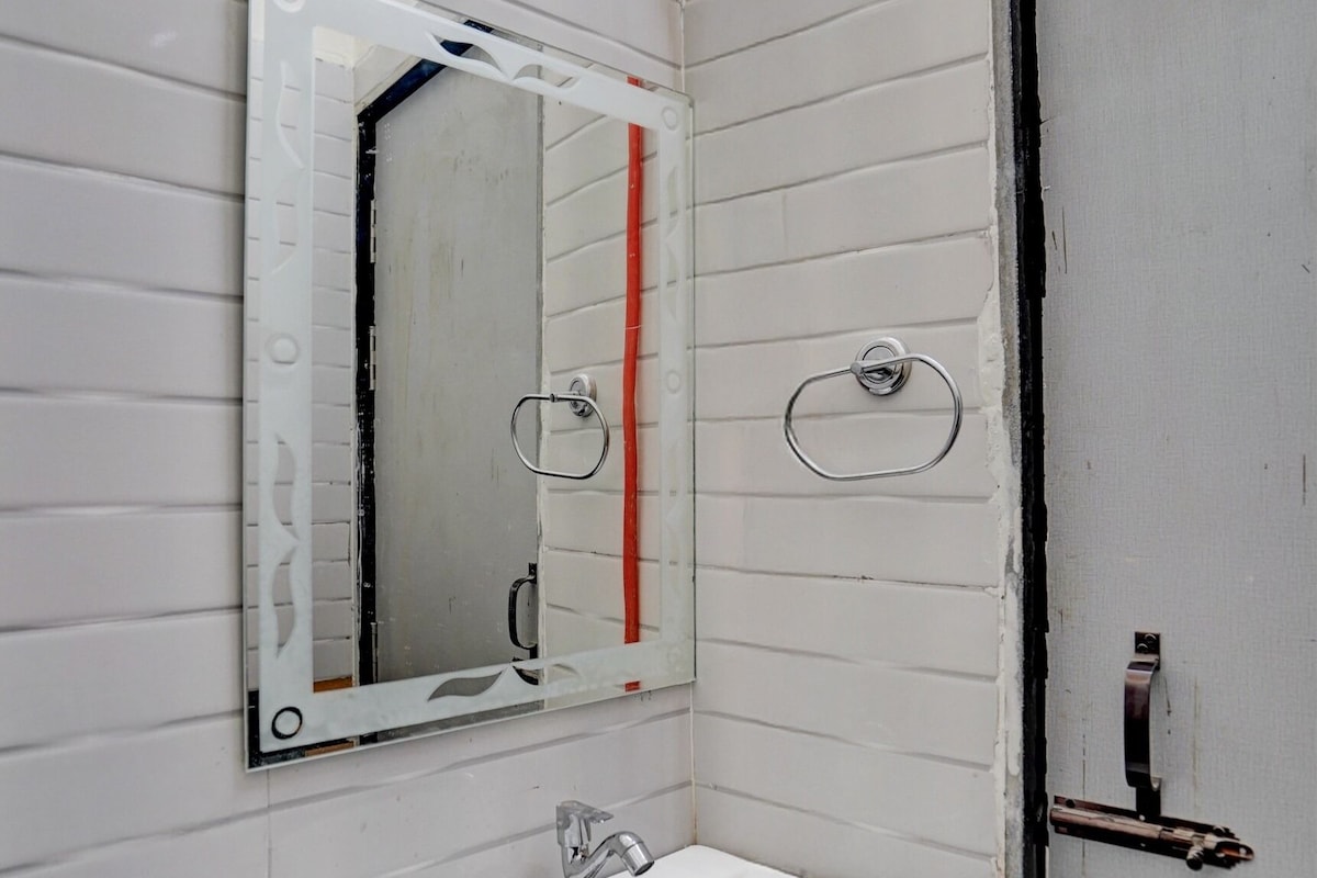 A bathroom with a white sink, a mirror, and a door.