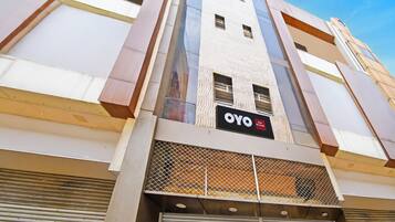 A hotel building with a prominent sign reading 'OYO Hotel Shily Shaka'.