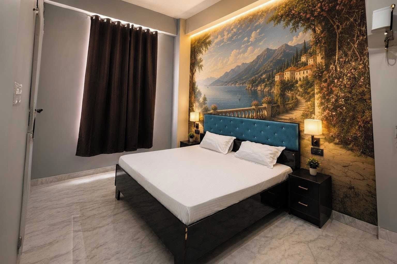 A bedroom with a bed, a painting of a coastal scene, a window with curtains, and a nightstand with a lamp.