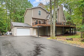 A two-story house with a garage, a covered porch, and a deck. - 9BR Lake Harmony Luxury/Hot Tub, Deck Bar & Zero Gravity Massage Chairs (Lake Harmony)