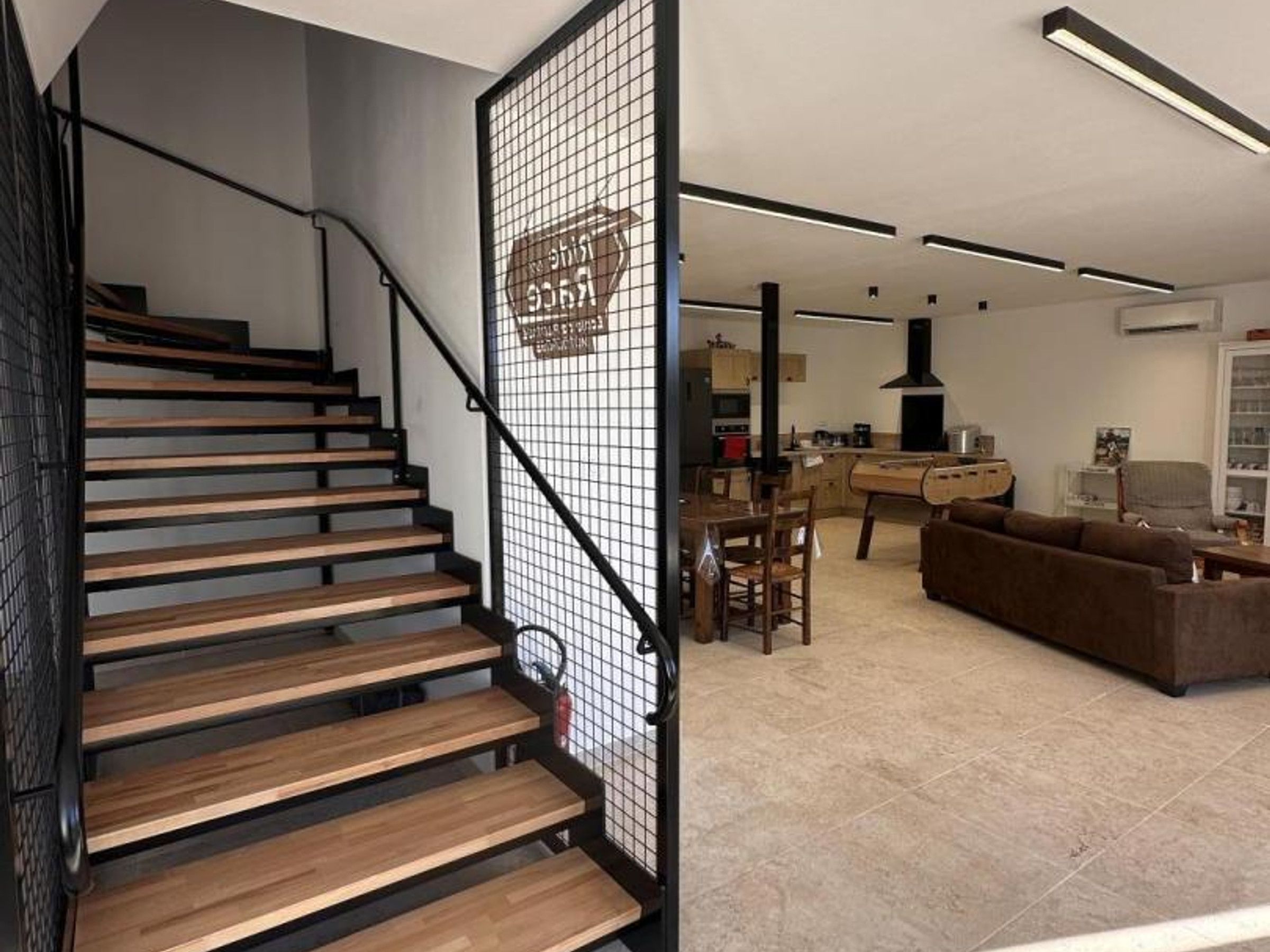 A modern interior with a wooden staircase, a dining area, and a living space.