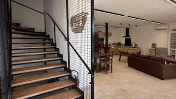 A modern interior with a wooden staircase, a dining area, and a living space.