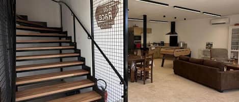 A modern interior with a wooden staircase, a dining area, and a living space.