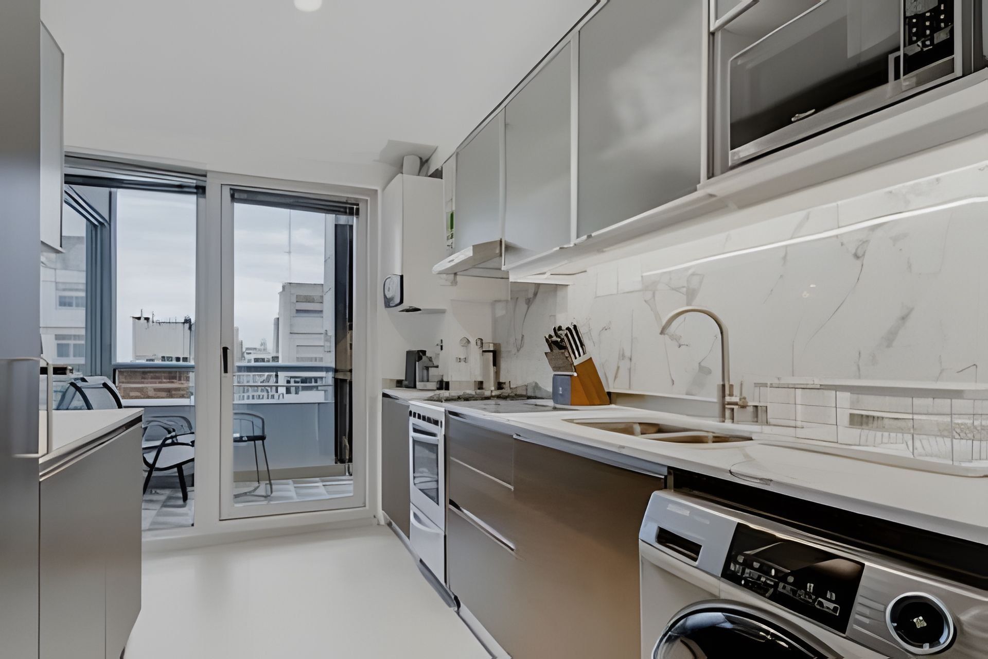 A modern kitchen with a built-in oven, microwave, and dishwasher.