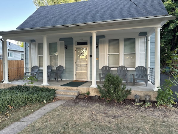 A house with a porch, a front door, and a mailbox.