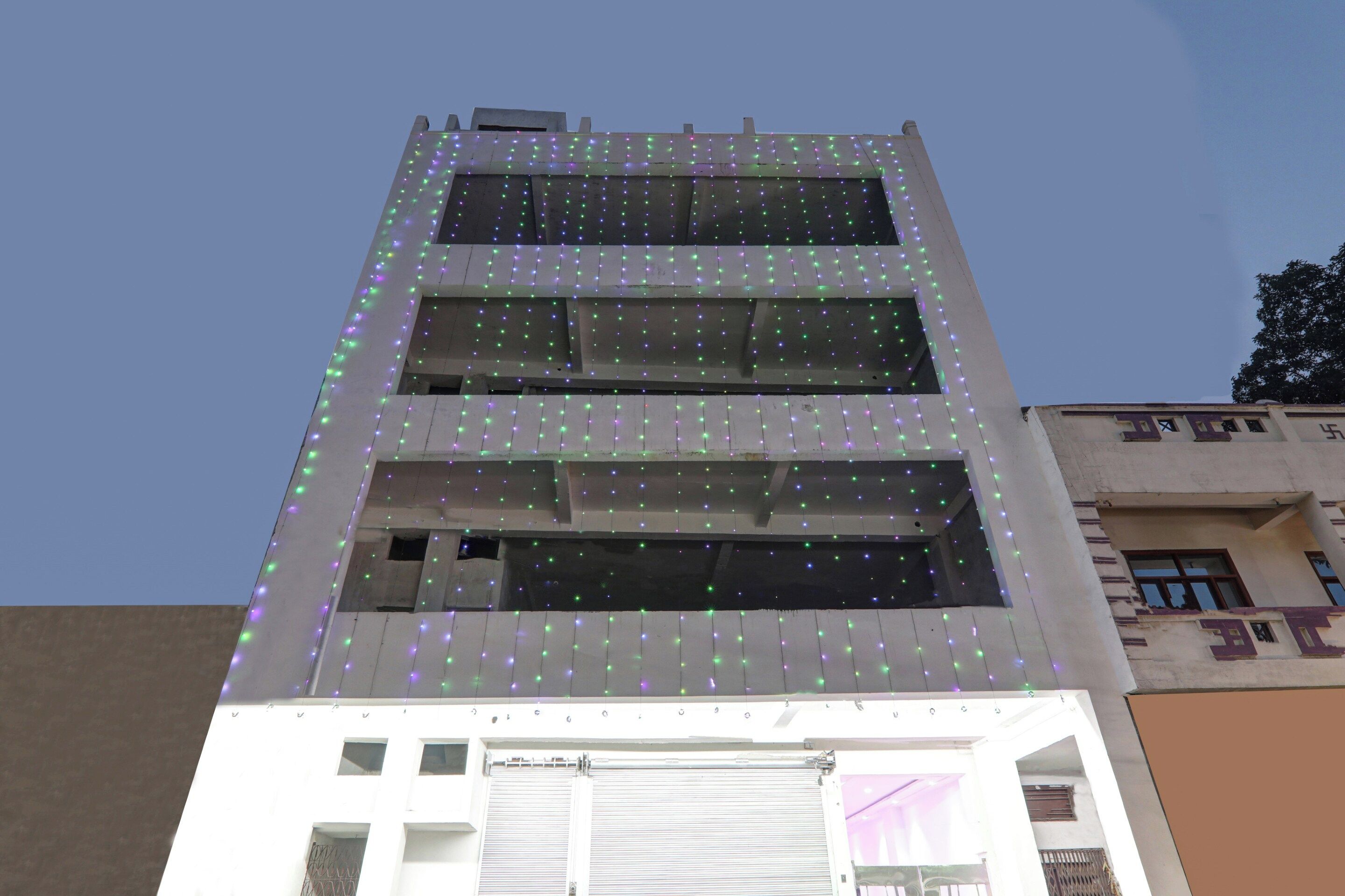 A multi-story building with a flat facade and a series of windows.