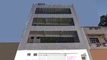 A multi-story building with a flat facade and a series of windows.