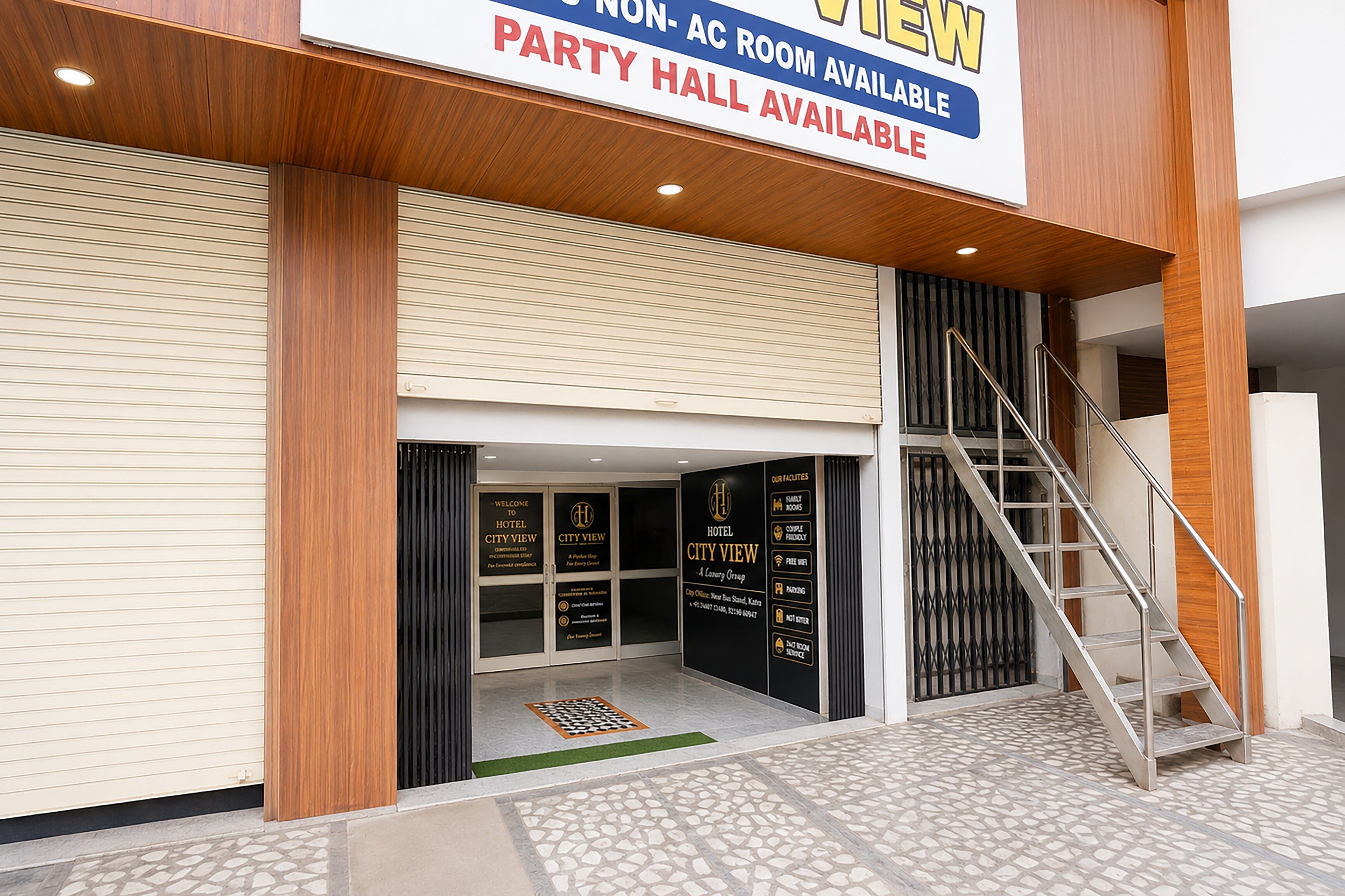A hotel entrance with a sign indicating a party hall is available.