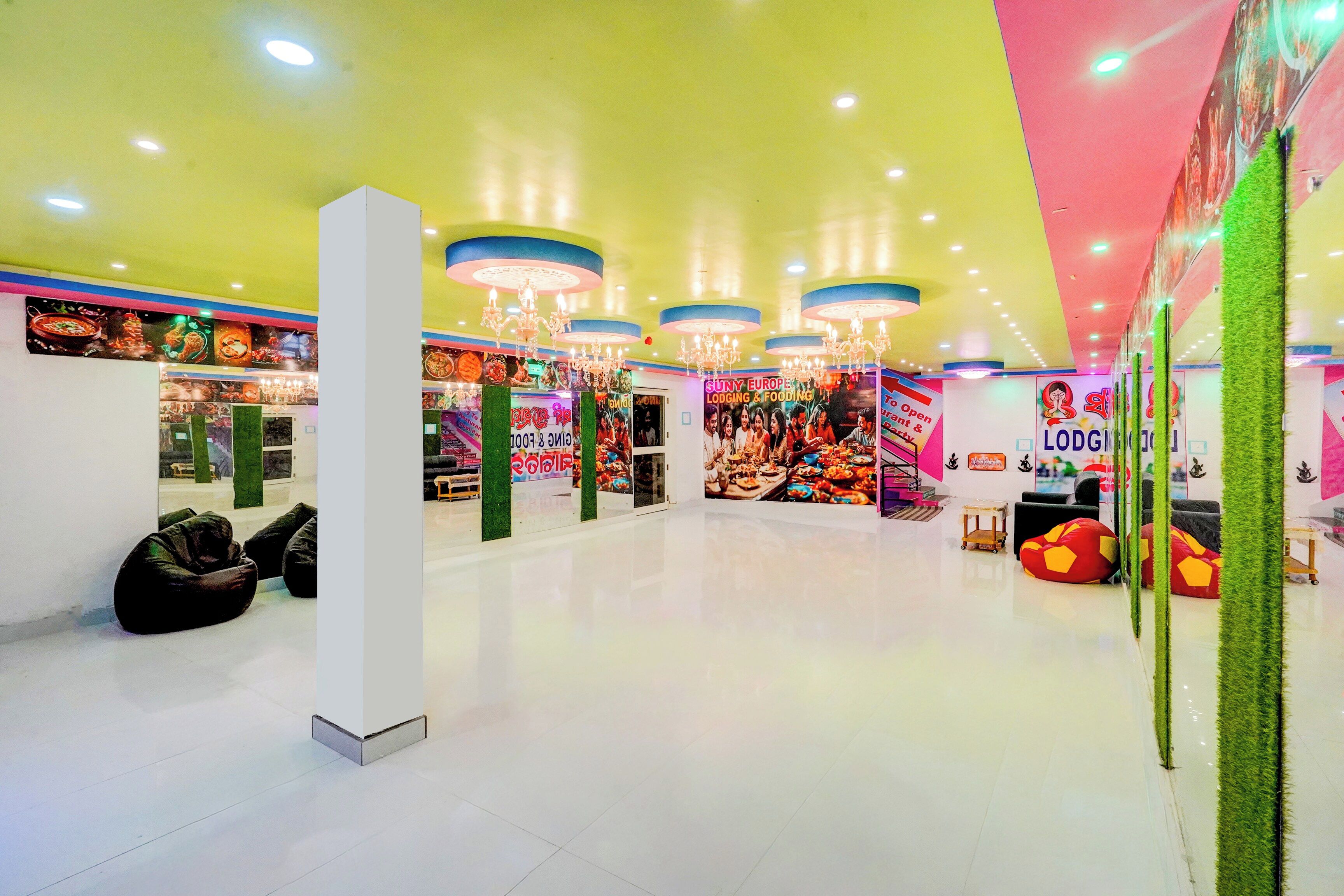 A brightly lit indoor space with multiple seating areas, including bean bags and a white pillar.