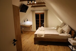 A bedroom with a wooden bed, a desk, and a chair. - New Listing (Lieschen)