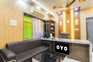 A reception area with a sofa, a glass-top desk, and a sign that reads 'OYO'. - Hotel O S.S tower (Kanpur)