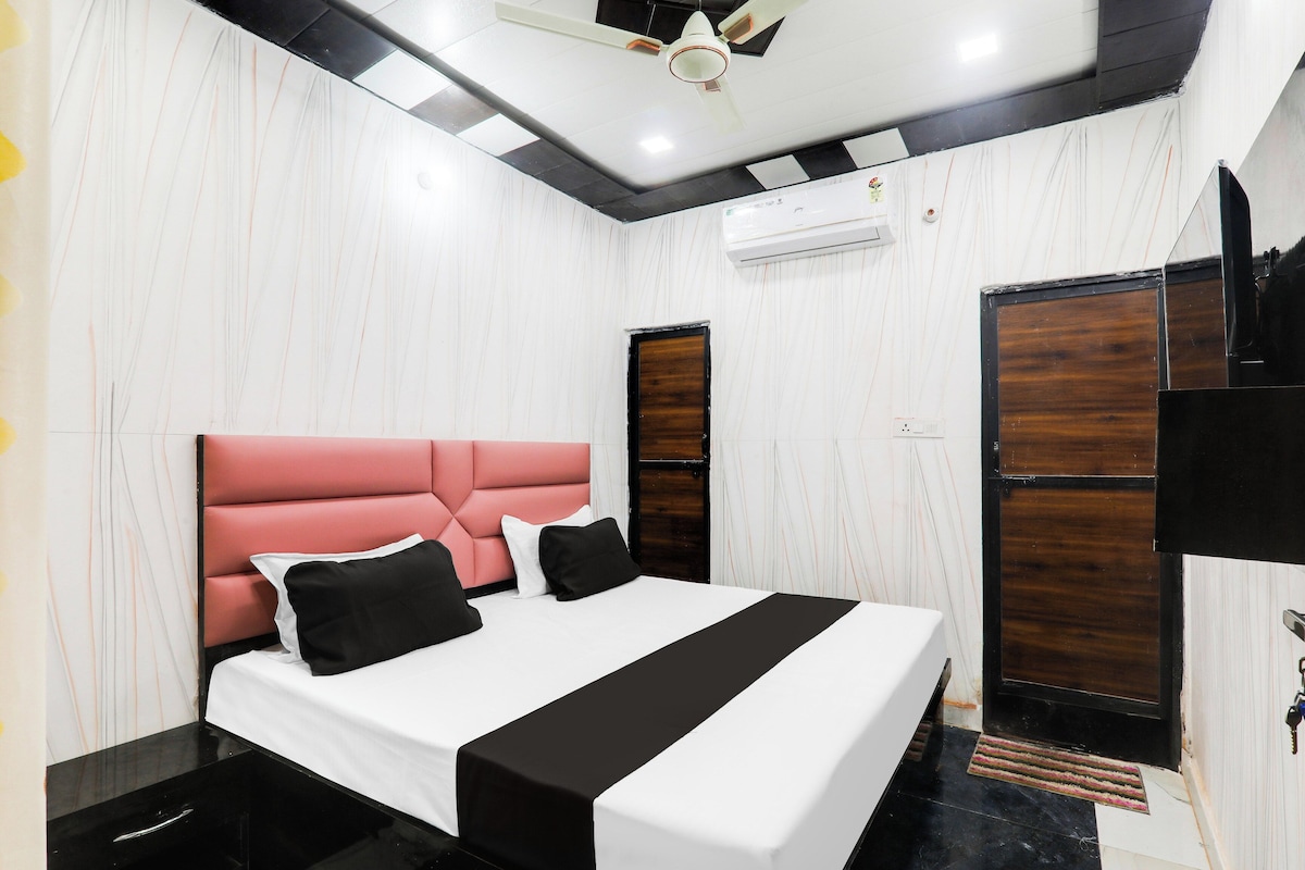 A modern bedroom with a bed, a ceiling fan, and a wardrobe.