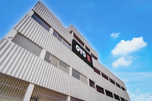 A hotel with a modern architectural design, featuring a prominent signboard and multiple windows. - Hotel O Sri Ram Guest House (Kendrapara)