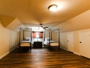A room with two beds, a ceiling fan, and a window with blinds. - Spacious 6-bedroom house in serene Tulsa with cool AC (Tulsa)