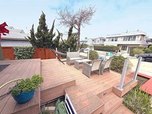 A wooden deck with outdoor furniture, a hammock, and a potted plant. - La Jolla Coastal Retreat Walk to the Beach, Dining and Designated Parking (San Diego)
