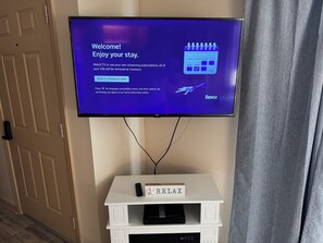 A television mounted on a wall displaying a welcome message and options for selecting a checkout date. - Waterfront Port Isabel/South Padre Condo for long term rent!! Sleeps 6 (Port Isabel)