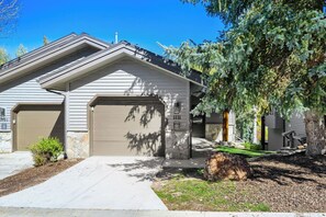 A residential building with a garage, a driveway, and a well-maintained lawn. - Deer Valley Ski Retreat | Hot Tub & Fire Pit 1111 (Park city)