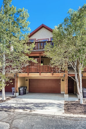 A two-story house with a balcony, a garage, and trees in the front yard. - Bear Hollow Beauty. Hottub Walk to Free Bus 5435 (Park City)