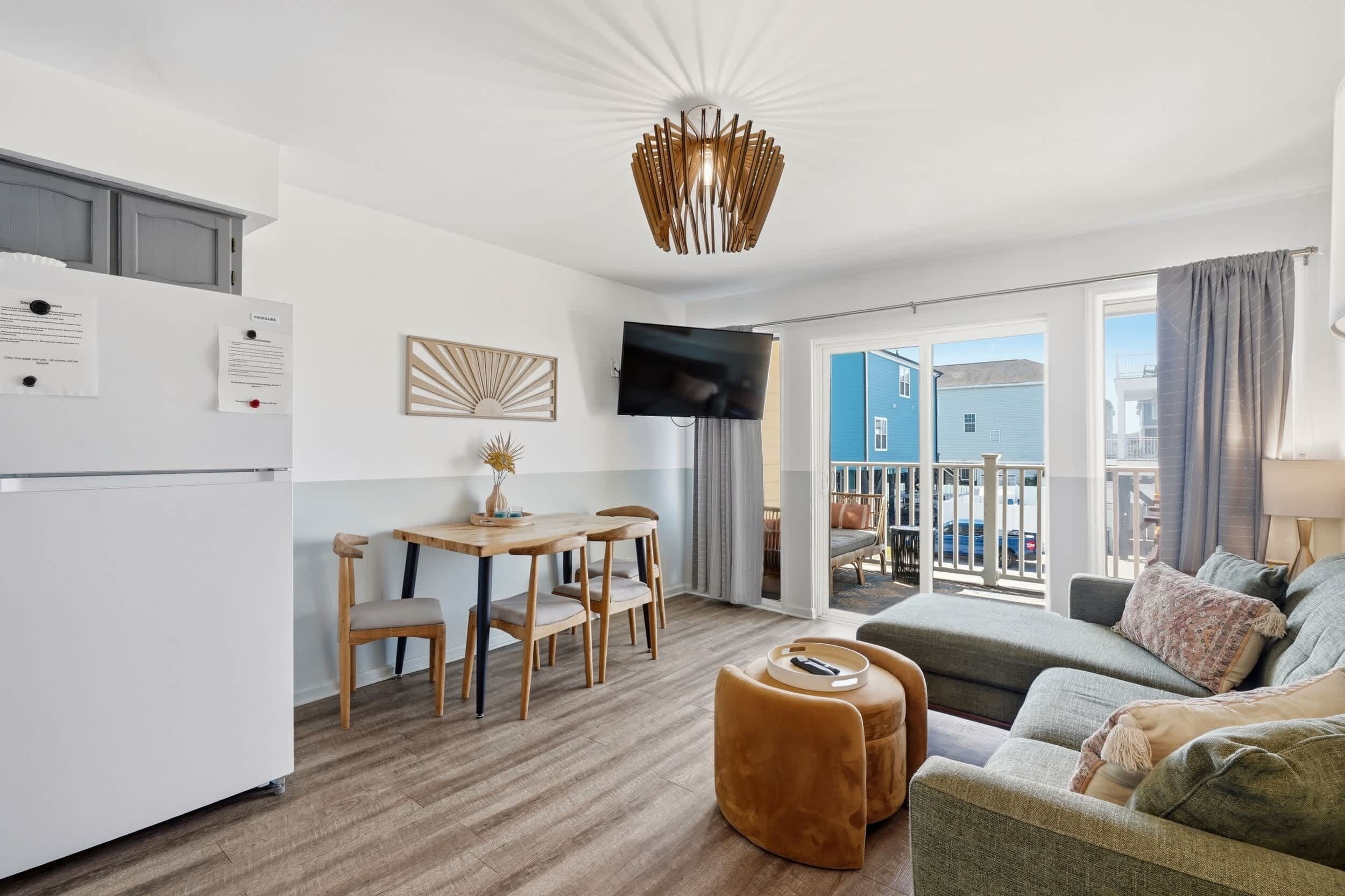 A modern apartment with a kitchen, dining area, and living room.