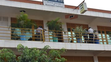 A building with a sign for 'Vine Inn Guest House & Business Centre' and a 'Vine Inn Accommodation' sign.
