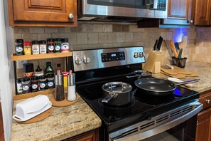 A kitchen with a stove, oven, and various cooking utensils. - Mayo Guests - Relax with Massage Chair, Pool Table, Fire pit & Yard. (Jacksonville)