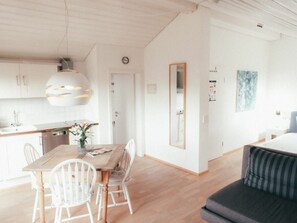 A modern interior with a dining area, a sofa, and a kitchen. - House Luna - Apartment Luna 4 (Schwangau)