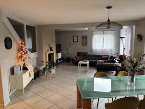 A living room with a sofa, a coffee table, a TV, and a Christmas tree. - New Listing (Epagny Metz Tessy)