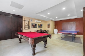 A billiards room with a pool table, a ping pong table, and a dining area. - Grand Venetian Oceanview Penthouse (Puerto Vallarta)