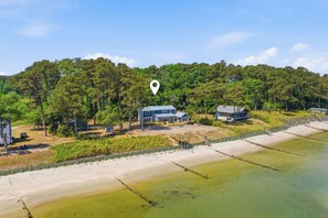 A coastal property with a large house, a smaller building, and a fenced beach area. - Luxury Beach Hs w/ 4 Suites, PrivateBeach & Htub (Heathsville)