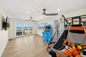 A spacious room with a basketball hoop, a pool table, and a view of the ocean. - Luxury Beach Hs w/ 4 Suites, PrivateBeach & Htub (Heathsville)
