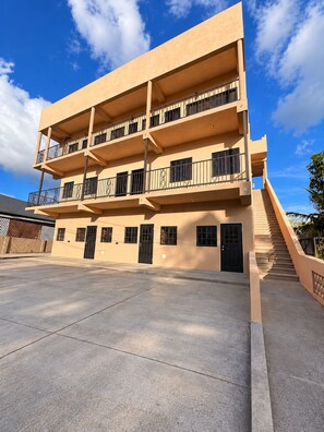 A multi-story building with balconies, a staircase, and a flat entrance area. - Lovely studio with AC in peaceful Lambeau (Lambeau)