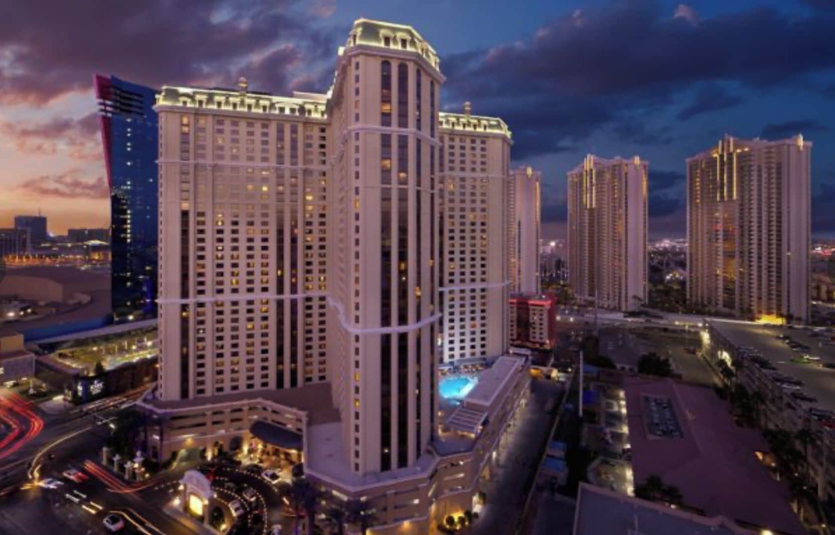 A high-rise hotel with multiple floors, a central atrium, and a parking area.