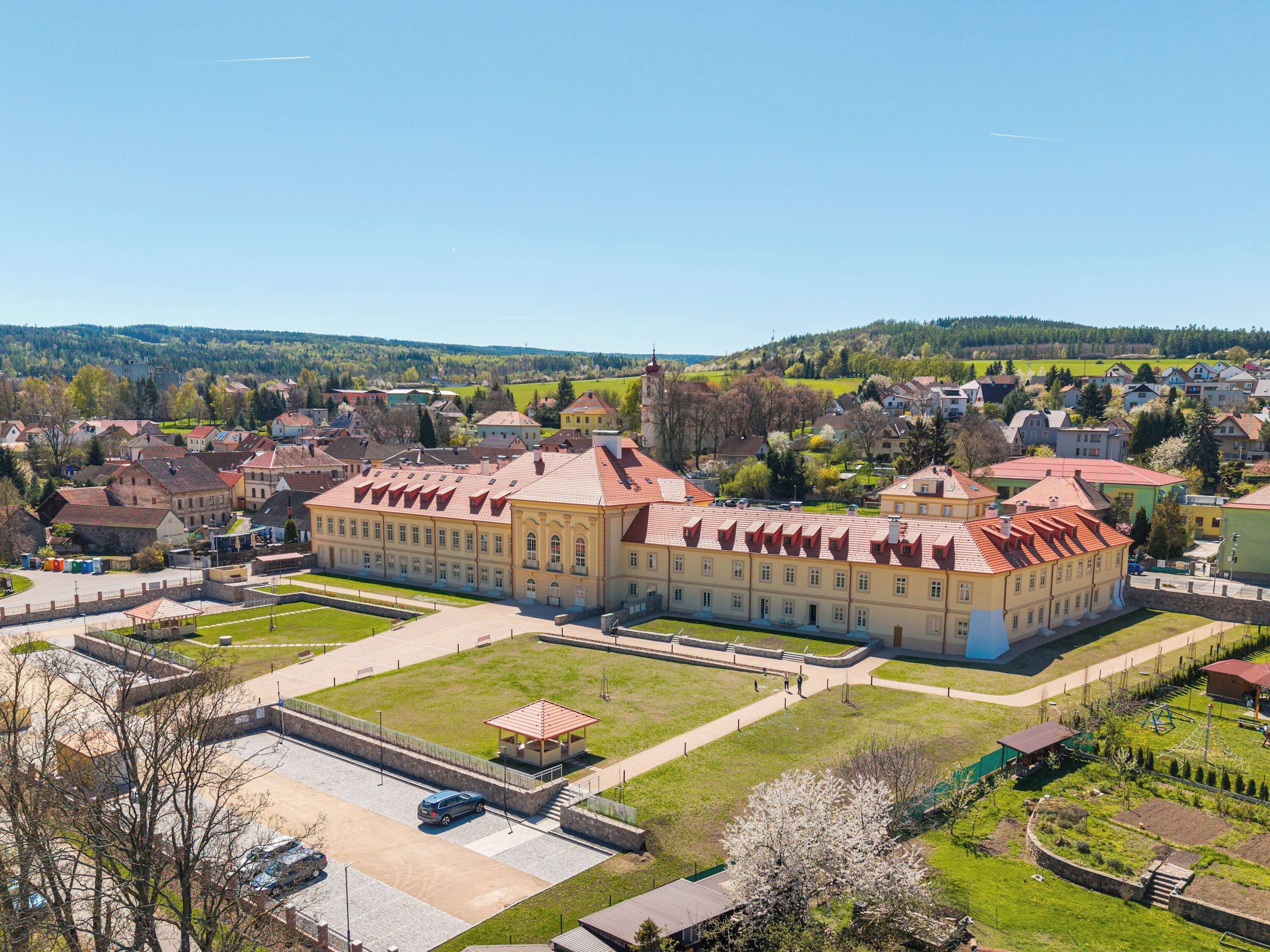 Un grand bâtiment historique doté de plusieurs ailes et d’une cour intérieure.