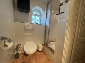 A bathroom with a toilet, bidet, and a shower area. - Holiday Apartment in Sylt With 1 Bedroom (Sylt)