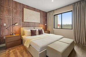 A bedroom with a large bed, two bedside lamps, a headboard, and a window with curtains. - Pininfarina Masterpiece 4 BD/4.5 BA - 5534 PW (Kissimmee)