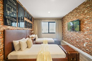 A hotel room with a brick wall, two beds, a large window, and a painting. - Pininfarina Masterpiece 4 BD/4.5 BA - 5534 PW (Kissimmee)