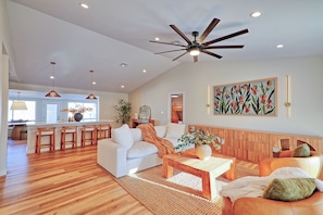 A spacious living area with a ceiling fan, wooden flooring, and a large window. - Scottsdale Retreat•Heated Pool•Sleeps 10 •Old Town (Scottsdale)