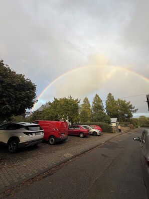 A parking area with vehicles and a rainbow in the background. - New Listing (Welschneudorf)