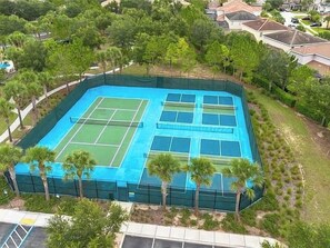 A tennis court surrounded by trees and a residential area. - 6 BD/ 5.5 BA/ Solterra Resort - 5207 WW (Davenport)