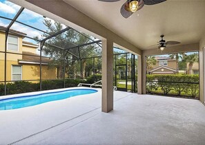 An indoor swimming pool area with a glass enclosure, ceiling fans, and a view of neighboring buildings. - 6 BD/ 5.5 BA/ Solterra Resort - 5207 WW (Davenport)