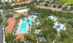 A residential area with a large swimming pool surrounded by palm trees and lounge chairs. - 6 BD/ 5.5 BA/ Solterra Resort - 5207 WW (Davenport)