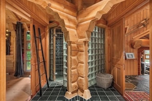 A log cabin interior with a unique wooden archway, a glass door leading outside, and a woven basket on the floor. - TH689 Log cabin by the Libakken lift, Sleeps 12 (Trysil)