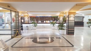 A reception area with a reception desk, potted plants, and a large floor number. - New Listing (Benalmádena)