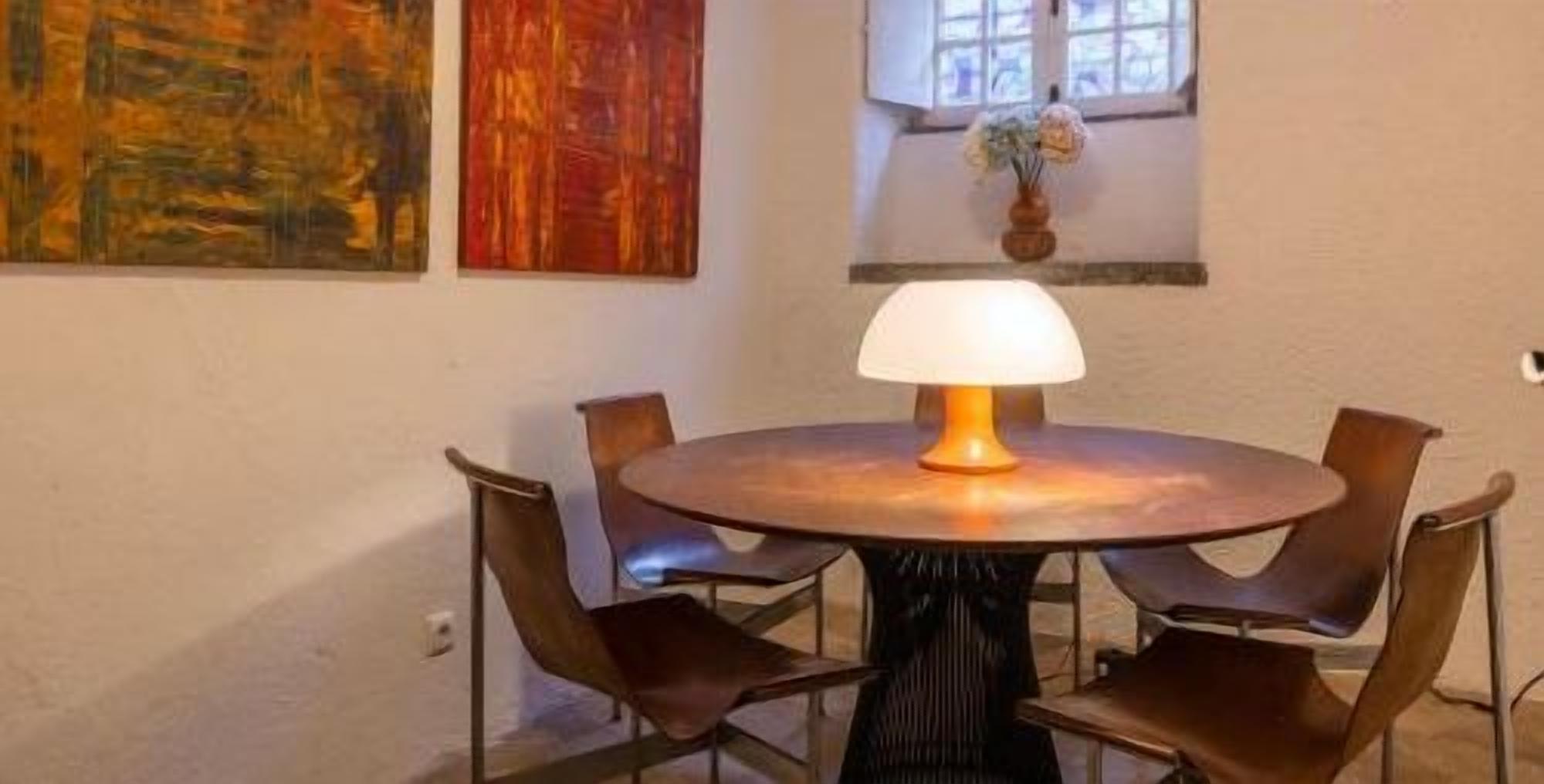 Cozy dining nook with modern seating, warm lighting, and artistic charm