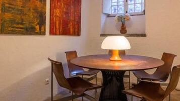 Cozy dining nook with modern seating, warm lighting, and artistic charm