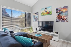 Bright modern lounge with large window, comfy sectional, and big TV - NEW King with Loft Beach Near Gulf (Gulfport)
