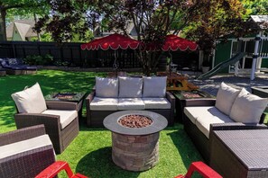 A backyard with outdoor furniture, a fire pit, and a slide. - BIG POOL!!! HOT TUB 5 bed 3 bath 3 min downtown (Providence)