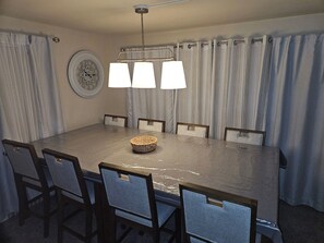 A dining area with a large table, chairs, a woven basket, and a wall clock. - BIG POOL!!! HOT TUB 5 bed 3 bath 3 min downtown (Providence)