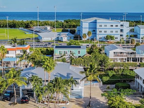 A coastal hotel with multiple buildings, a swimming pool, and a view of the ocean. - Sombrero Beach Hideaway | Dockage, Close to Beach (Marathon)
